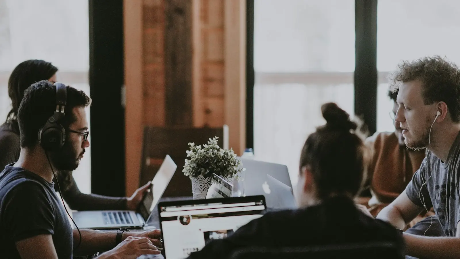 Frustrated small business employee at computer with phone