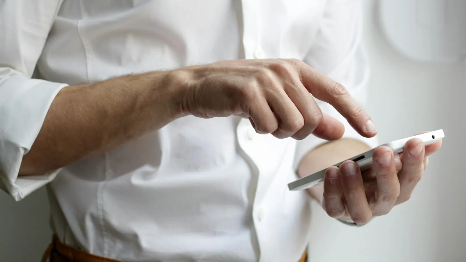 Office manager texting an IT help desk from a small business front desk