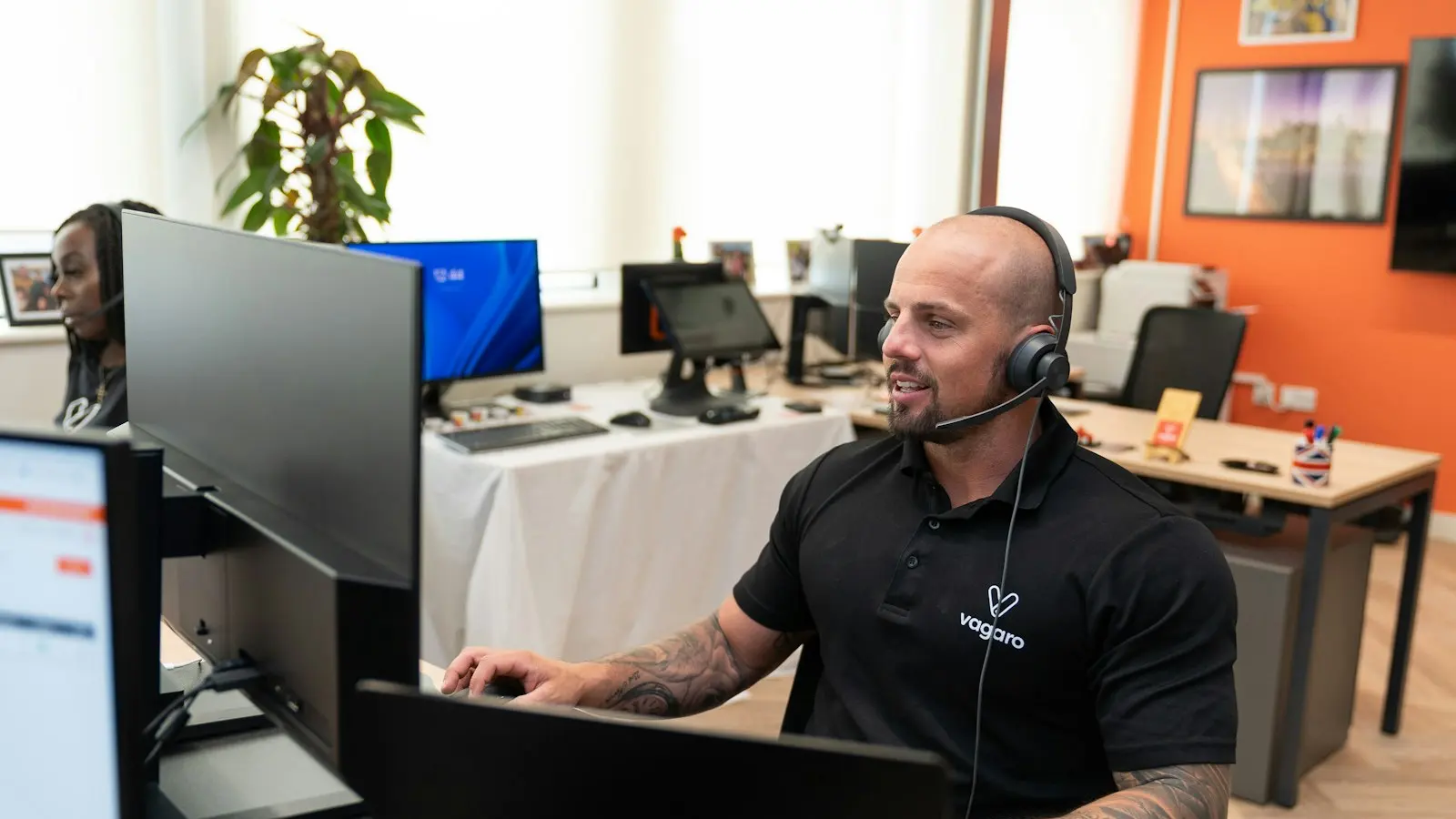 Technician helping a small business owner with a laptop